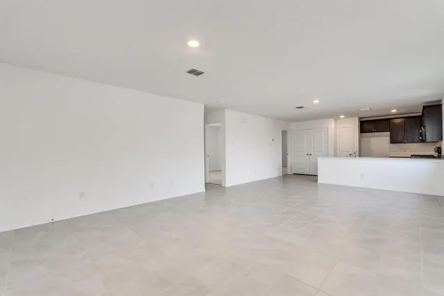 a view of a kitchen with a sink and a refrigerator