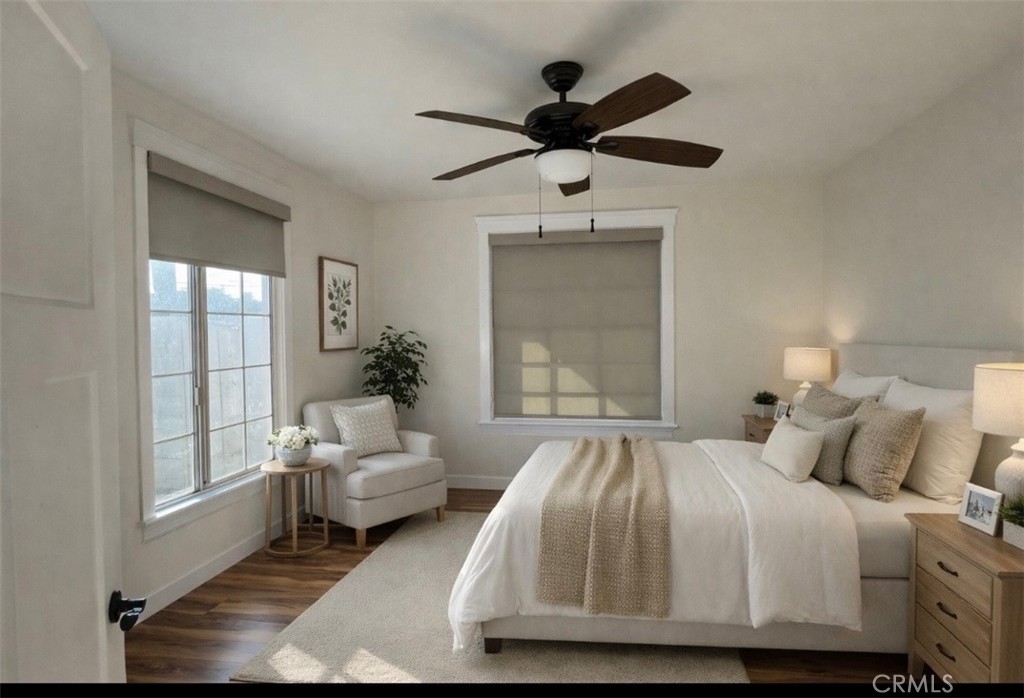 5012 Brockton Avenue Riverside, CA 92506 - Photo 13 of 28 a bedroom with a large bed chandelier and a window