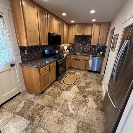 a kitchen with a stove a sink and a refrigerator