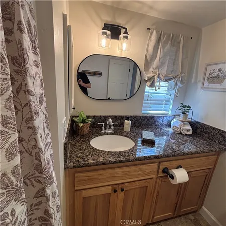a bathroom with a shower curtain and a toilet