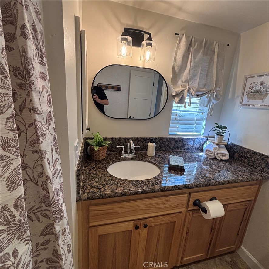 5012 Brockton Avenue Riverside, CA 92506 - Photo 25 of 28 a bathroom with a sink and a mirror