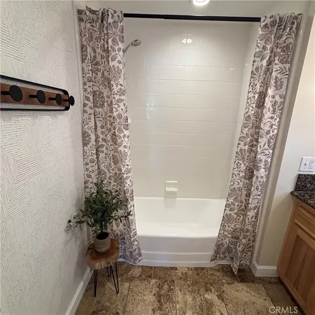 a bathroom with a shower curtain and a bathtub