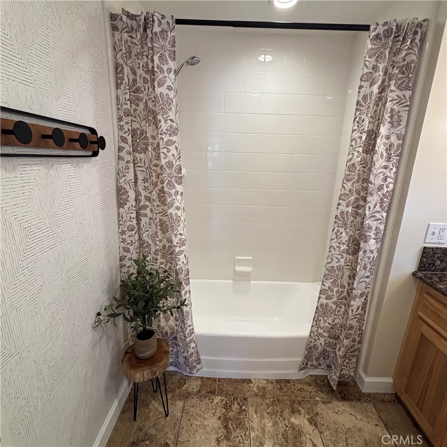 5012 Brockton Avenue Riverside, CA 92506 - Photo 26 of 28 a bathroom with a shower curtain and a toilet