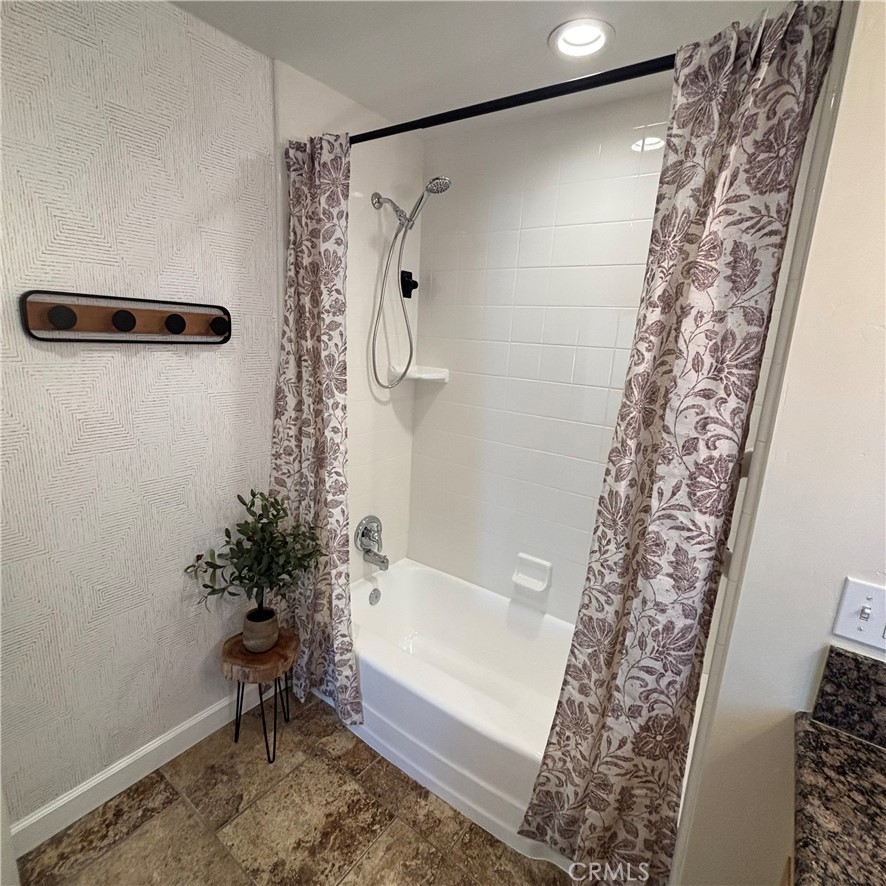 5012 Brockton Avenue Riverside, CA 92506 - Photo 27 of 28 a bathroom with a shower curtain and a bathtub