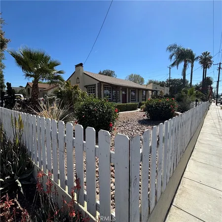 a view of a house with wooden fence