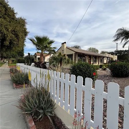a view of a house with wooden fence