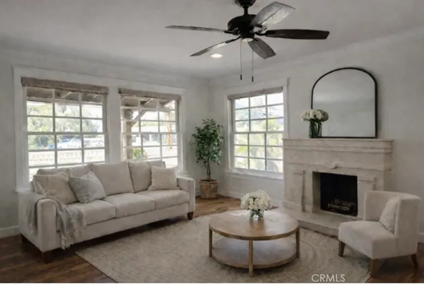 a living room with furniture a fireplace and a large window
