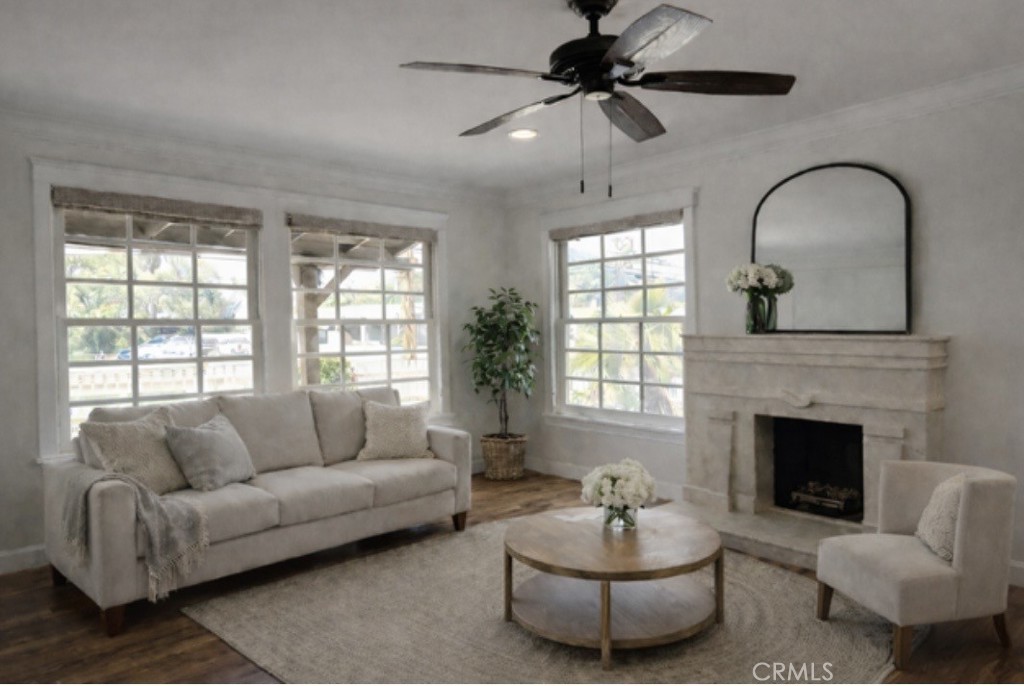 5012 Brockton Avenue Riverside, CA 92506 - Photo 9 of 28 a living room with furniture a fireplace and a large window