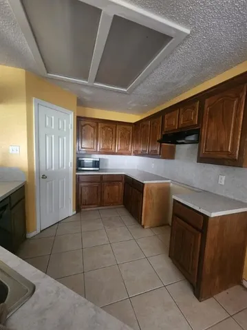a kitchen with stainless steel appliances granite countertop a sink and cabinets