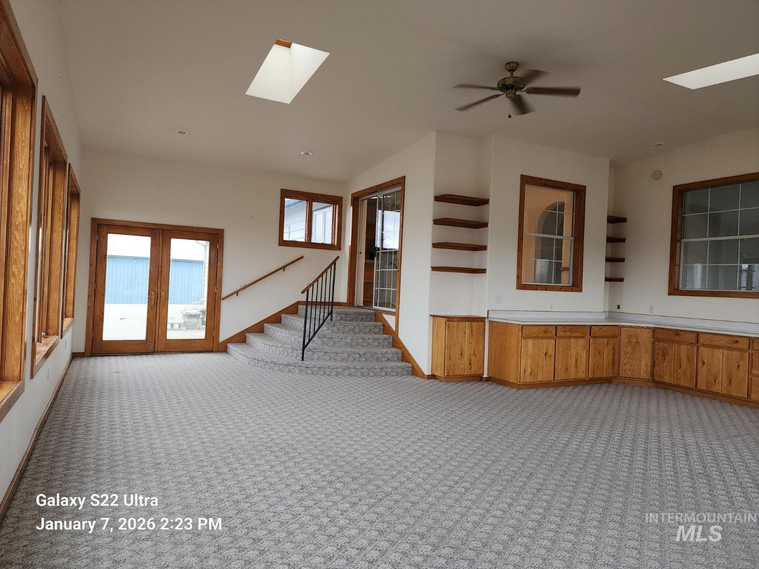 650 Ash Street Vale, OR 97918 - Photo 11 of 23 Unfurnished room featuring a skylight, light colored carpet, and stairway