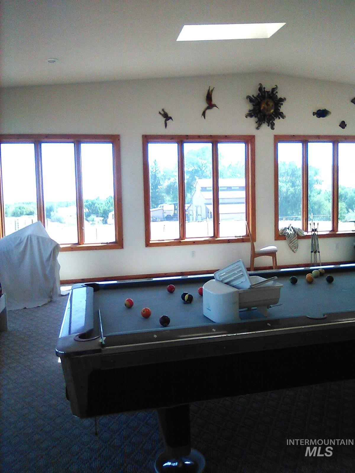 650 Ash Street Vale, OR 97918 - Photo 12 of 24 Recreation room with healthy amount of natural light, pool table, lofted ceiling, and carpet flooring