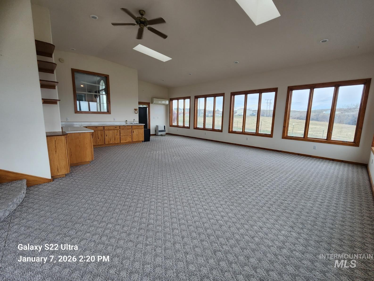 650 Ash Street Vale, OR 97918 - Photo 13 of 23 Unfurnished living room featuring a skylight, vaulted ceiling, carpet, and ceiling fan