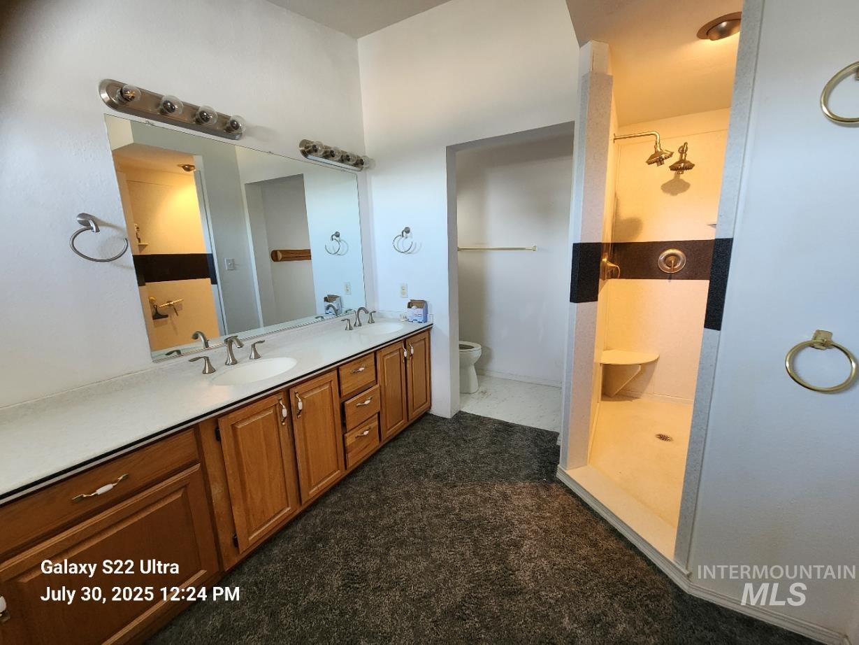 650 Ash Street Vale, OR 97918 - Photo 19 of 24 Bathroom featuring double vanity and a walk in shower