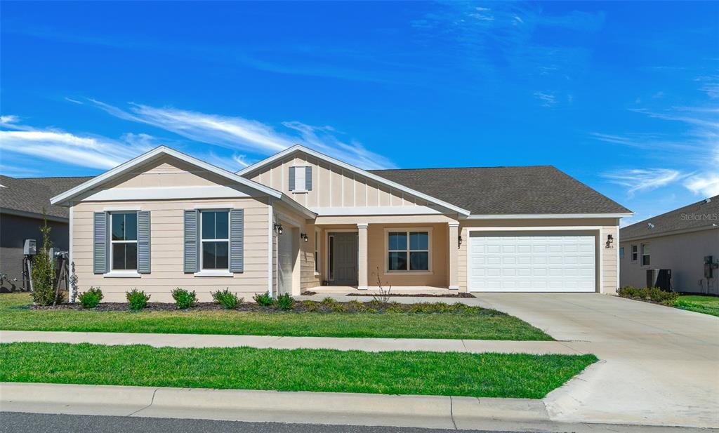6303 Southwest 75th Ct Road Ocala, FL 34474 - Photo 2 of 50 a front view of a house with a yard
