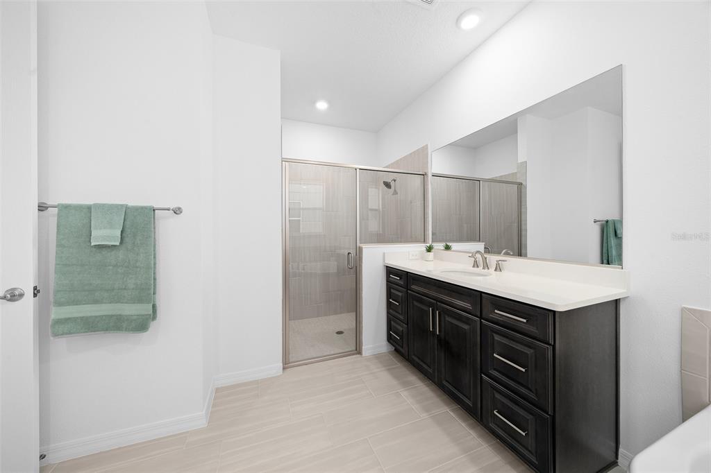 6303 Southwest 75th Ct Road Ocala, FL 34474 - Photo 25 of 50 a bathroom with a sink double vanity and a mirror