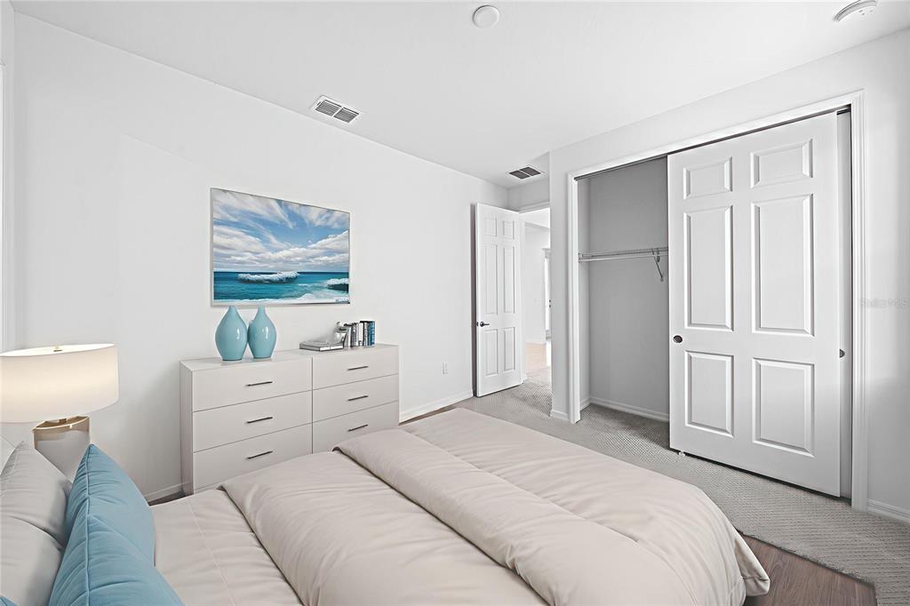 6303 Southwest 75th Ct Road Ocala, FL 34474 - Photo 26 of 50 a bedroom with a bed and a painting on the wall