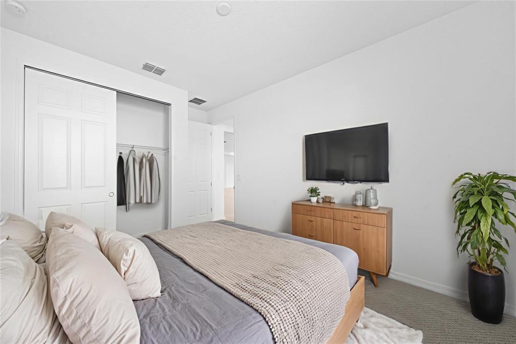 6303 Southwest 75th Ct Road Ocala, FL 34474 - Photo 29 of 50 a bedroom with a bed and a flat screen tv