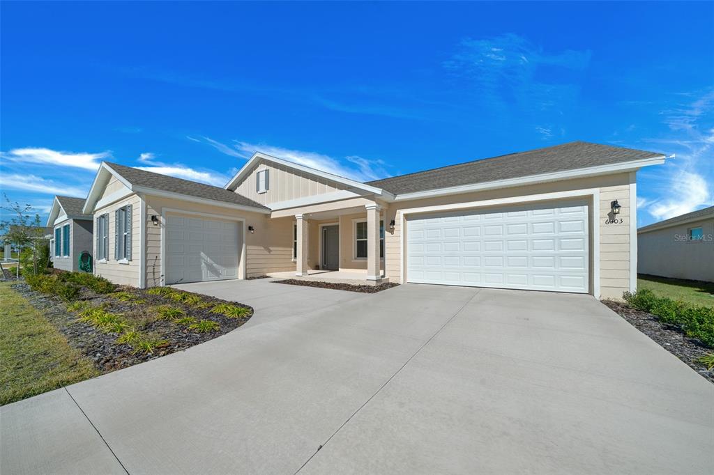 6303 Southwest 75th Ct Road Ocala, FL 34474 - Photo 3 of 50 a front view of a house with a garage