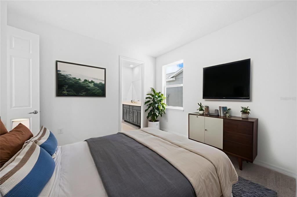 6303 Southwest 75th Ct Road Ocala, FL 34474 - Photo 33 of 50 a bedroom with a bed and a flat screen tv