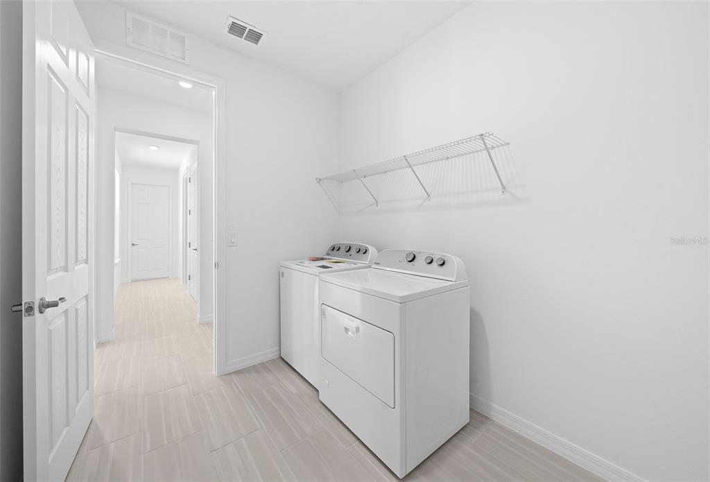 6303 Southwest 75th Ct Road Ocala, FL 34474 - Photo 40 of 50 a utility room with cabinets washer and dryer