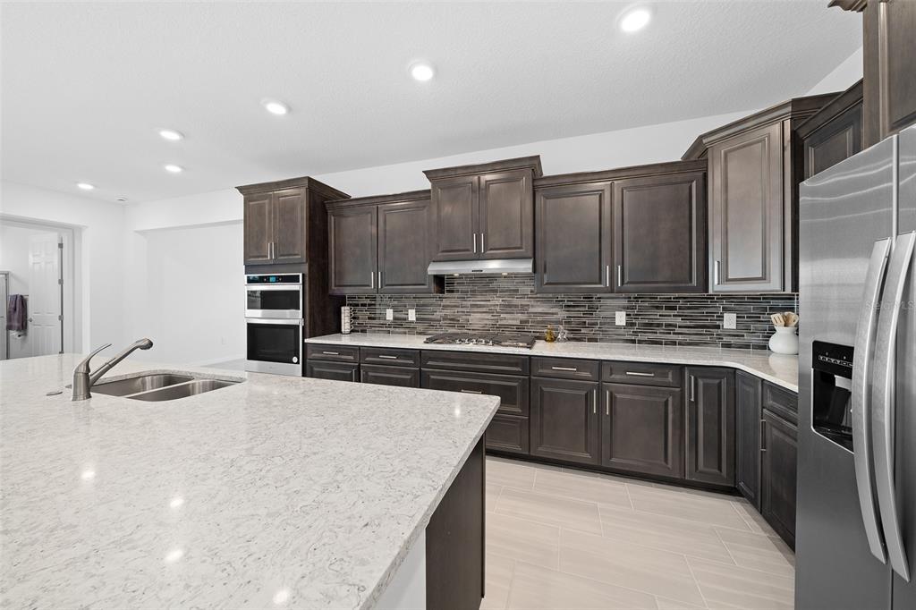 6303 Southwest 75th Ct Road Ocala, FL 34474 - Photo 7 of 50 a kitchen with stainless steel appliances granite countertop a sink refrigerator and cabinets