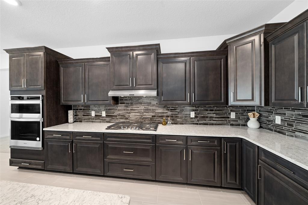 6303 Southwest 75th Ct Road Ocala, FL 34474 - Photo 8 of 50 a kitchen with stainless steel appliances granite countertop a sink stove and refrigerator