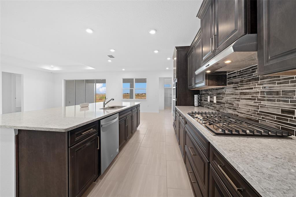 6303 Southwest 75th Ct Road Ocala, FL 34474 - Photo 9 of 50 a kitchen with stainless steel appliances granite countertop a sink a stove and a refrigerator
