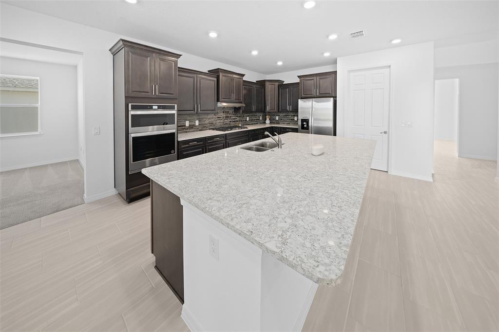 6303 Southwest 75th Ct Road Ocala, FL 34474 - Photo 10 of 50 a view of kitchen with kitchen island and stainless steel appliances