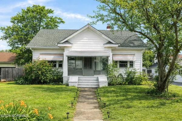 a front view of a house with a yard and porch