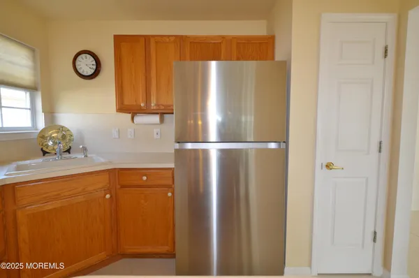 a kitchen with a refrigerator and cabinets