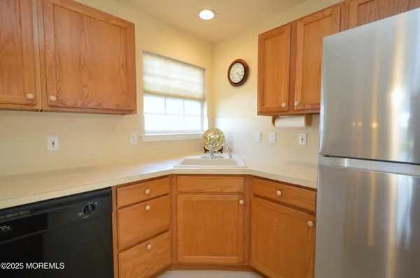 a kitchen with a refrigerator and a sink