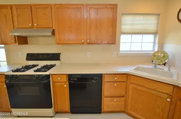 a kitchen with a sink stove and cabinets
