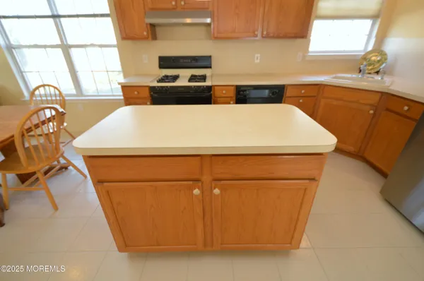 a kitchen with a refrigerator and a sink
