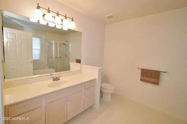 a white bath tub sitting next to a shower