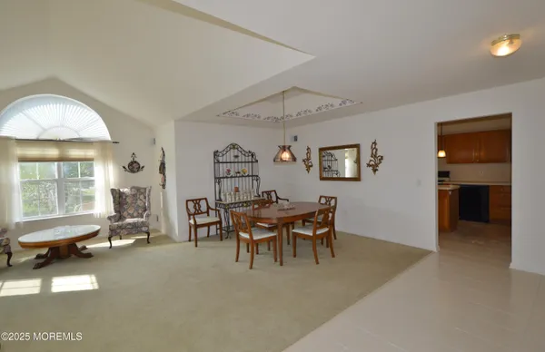 a view of a livingroom with furniture and a window