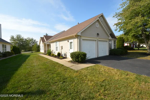 a front view of a house with yard and sitting area