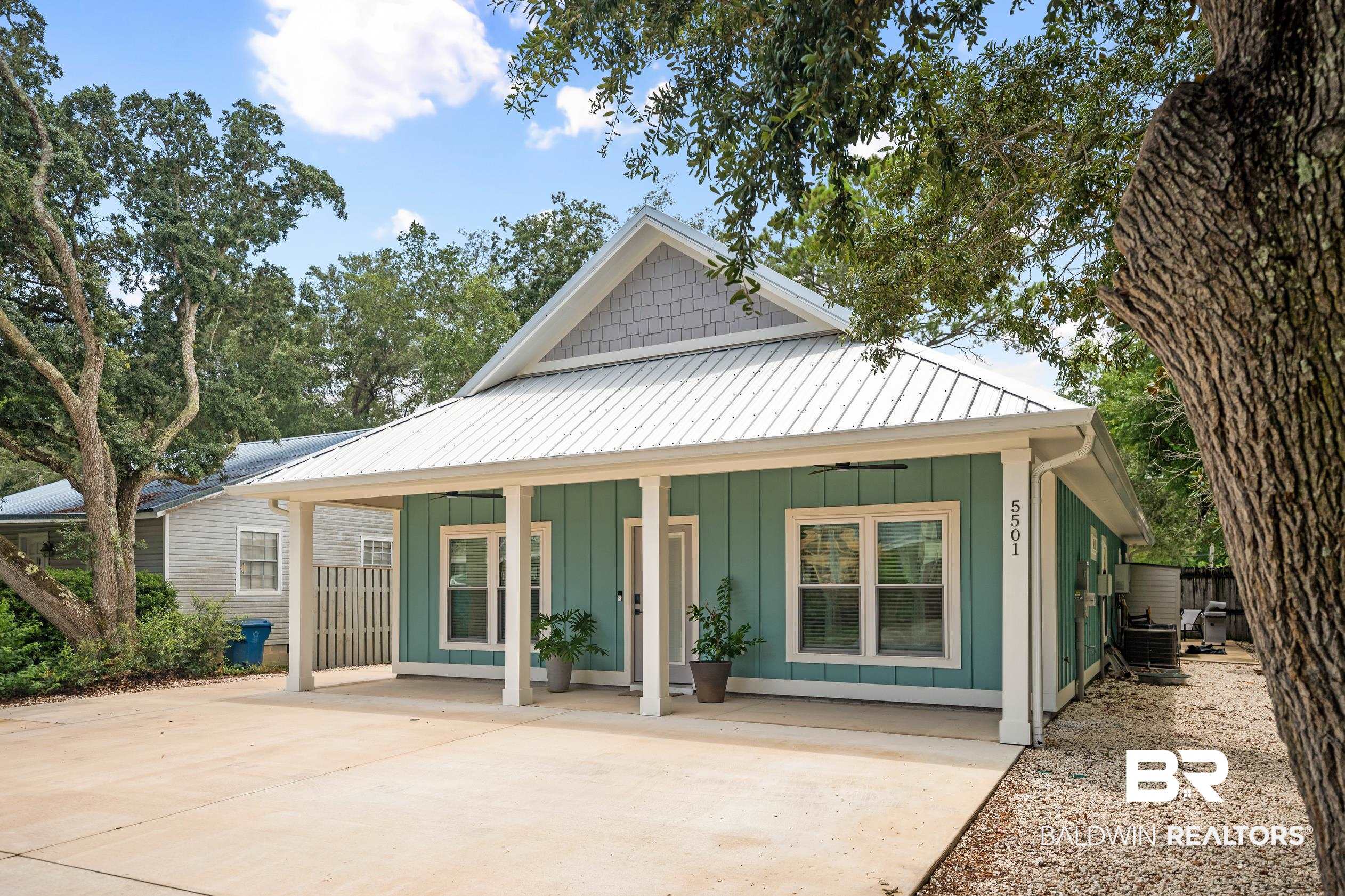 5501 Mobile Avenue Orange Beach, AL 36561 - Photo 1 of 40 View of front of home featuring board and batten siding, a porch, a metal roof, ceiling fan, and concrete driveway