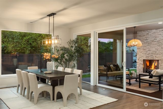 a view of a dining room and livingroom with furniture wooden floor a chandelier