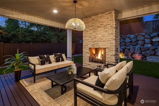 a roof deck with a dining table and chairs with wooden floor