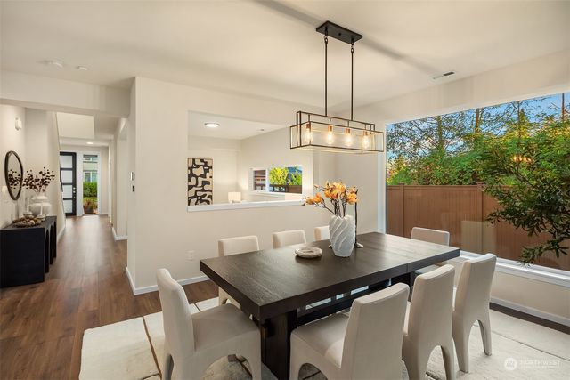a view of a dining room with a table and chairs