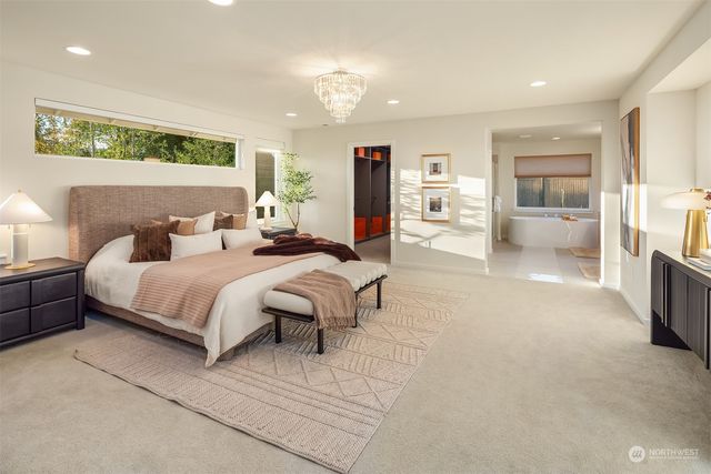 a bedroom with a large bed and a view of kitchen