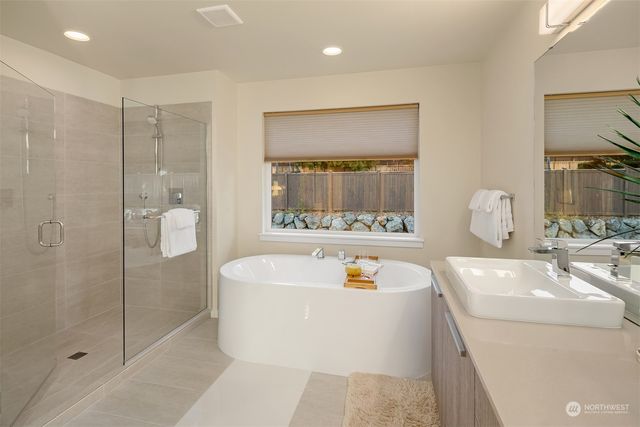 a bathroom with a tub sink and mirror