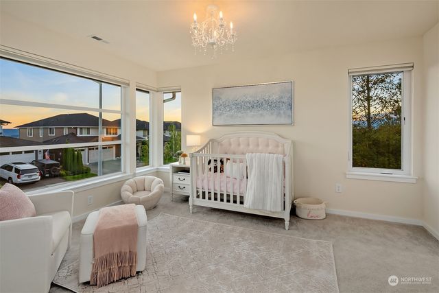 a bedroom with furniture and a large window