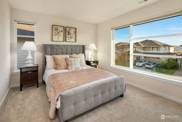 a bedroom with a bed and a large window
