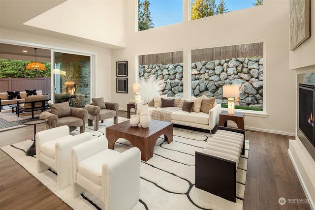 a living room with fireplace furniture and a large window
