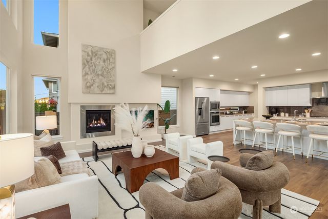 a living room with furniture kitchen view and a fireplace