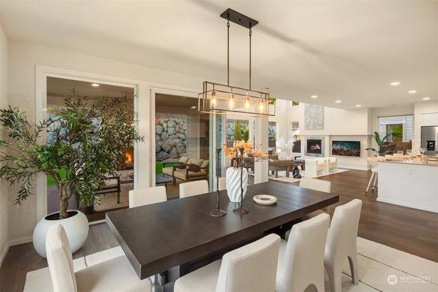 a kitchen with a table chairs stove and kitchen view
