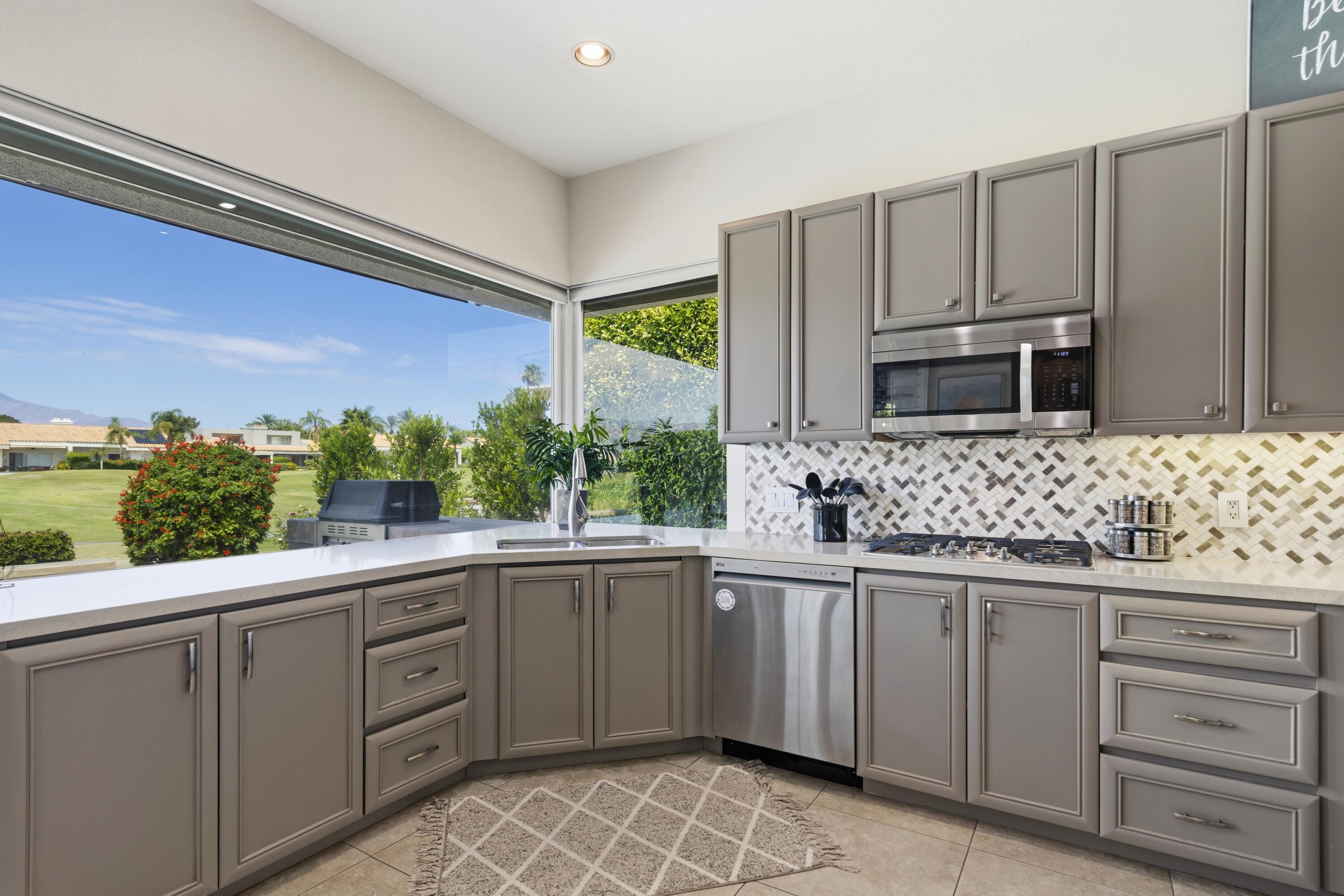 39 Augusta Drive Rancho Mirage, CA 92270 - Photo 17 of 53 a kitchen with a sink and cabinets
