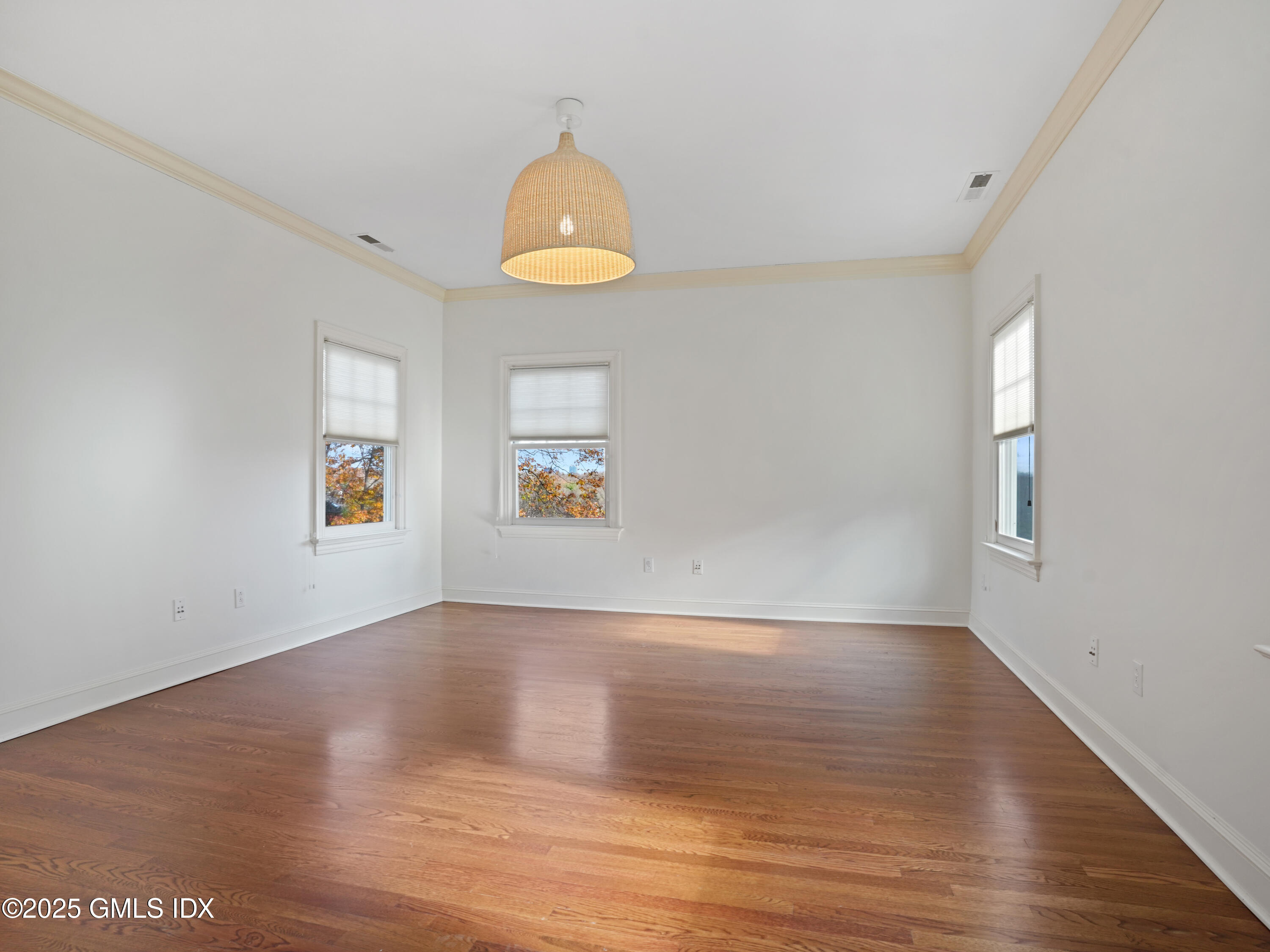77 Sheep Hill Road Riverside, CT 06878 - Photo 13 of 34 an empty room with wooden floor and windows
