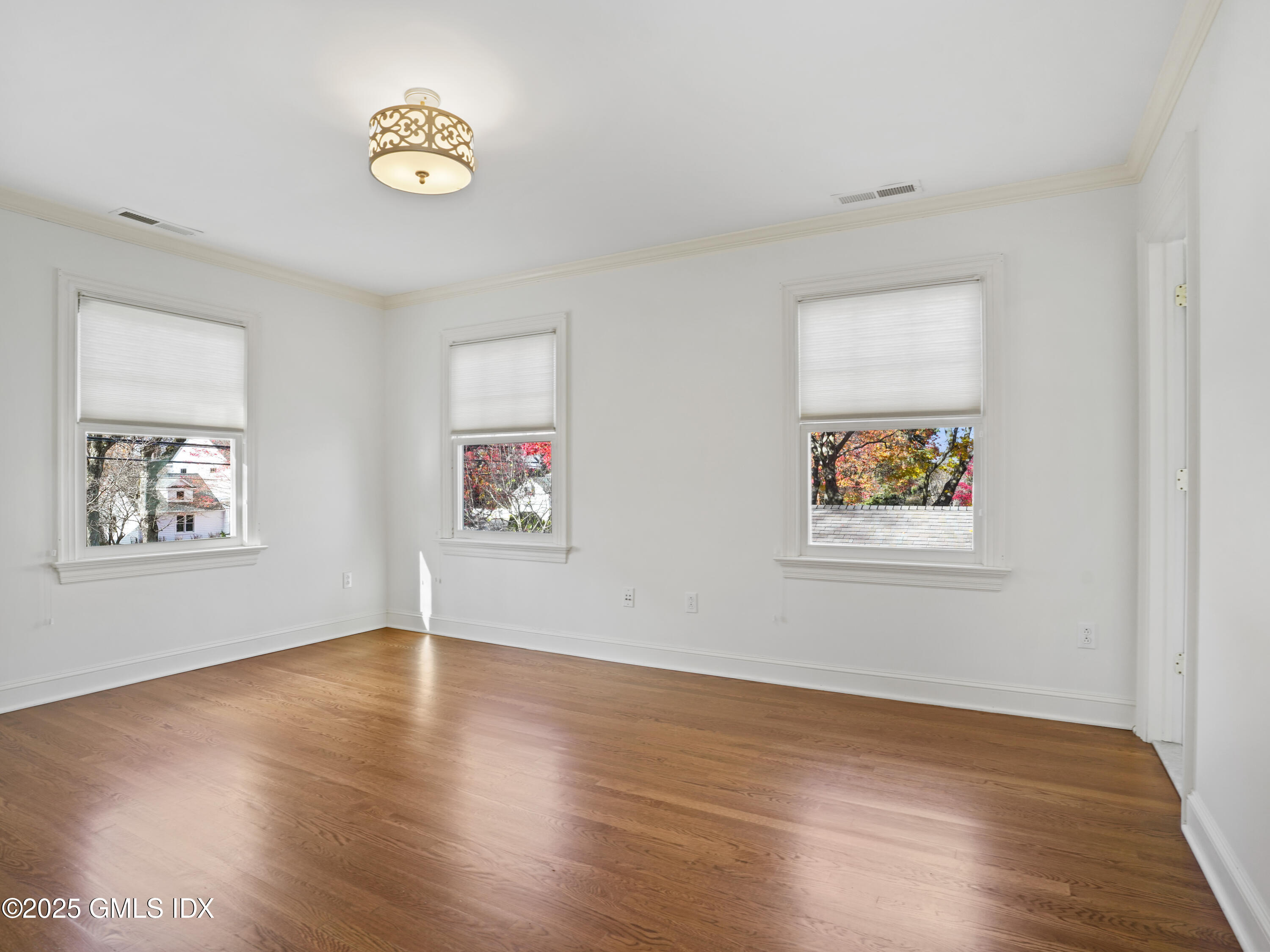 77 Sheep Hill Road Riverside, CT 06878 - Photo 16 of 34 an empty room with a wooden floor and a window